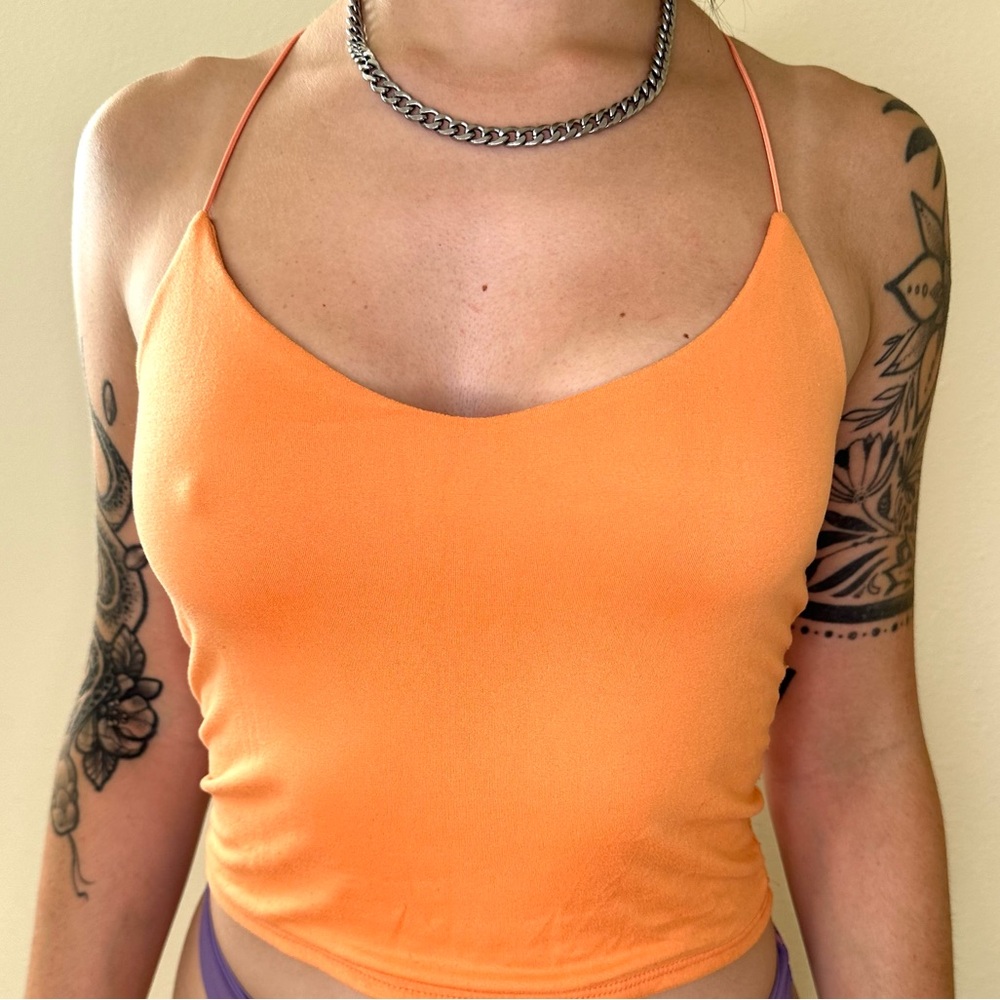 Bright orange, Live In The Moment cross back crop tank top.